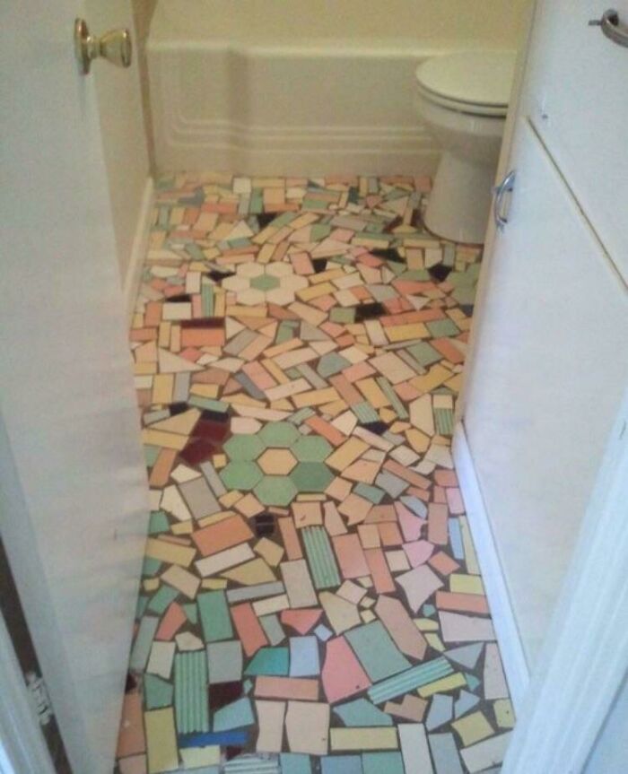 Mismatched and poorly laid mosaic tile floor showing a failed bathroom DIY renovation.