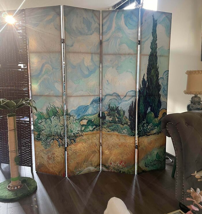 A decorative room divider screen featuring Vincent van Gogh artwork, a great thrift store find.
