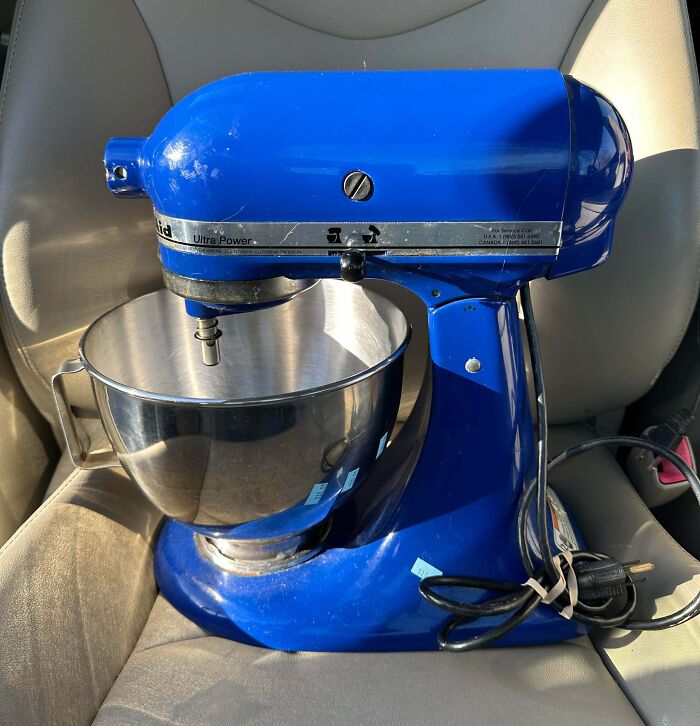 A vibrant blue KitchenAid stand mixer with a stainless steel bowl, a lucky find from a thrift store