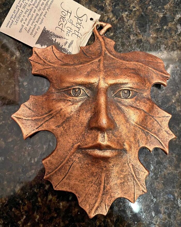 A detailed clay wall hanging resembling a leaf face, discovered among unique thrift store finds