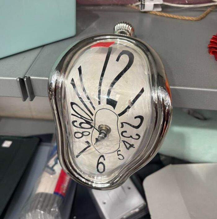 A melting clock in the style of Salvador Dali sitting on a shelf, a quirky thrift store find