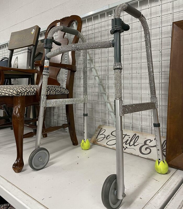 A bedazzled walker with glitter decoration, showcasing unusual thrift store finds on a shelf