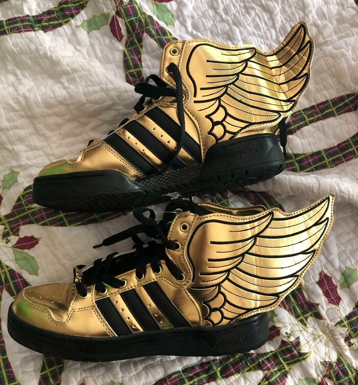 Pair of metallic gold high-top sneakers with wings, found as unique thrift store finds