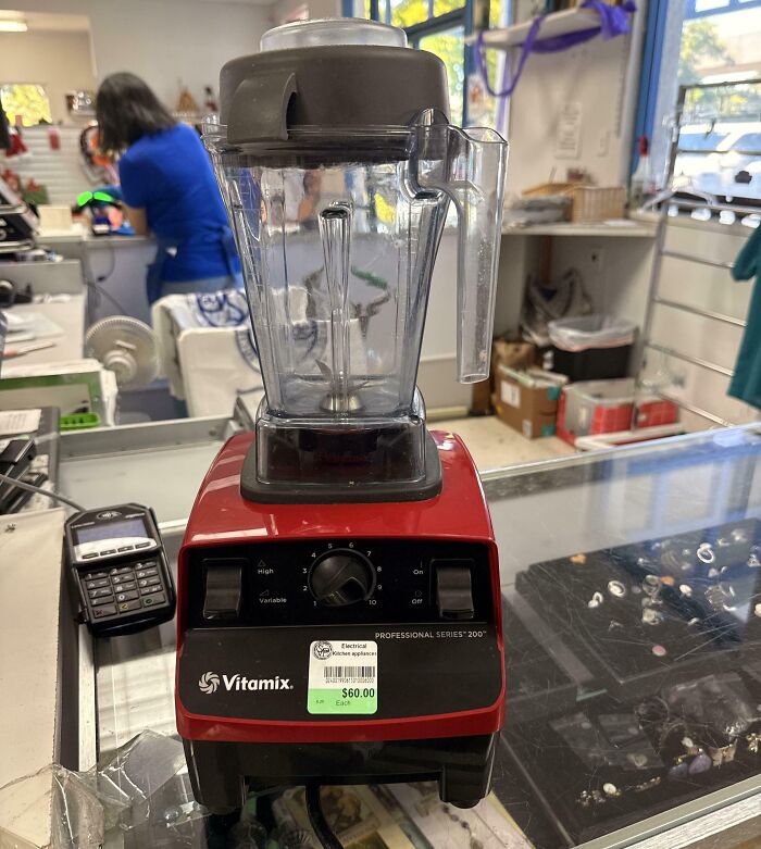 A red Vitamix professional blender sitting on a counter, a lucky thrift store find
