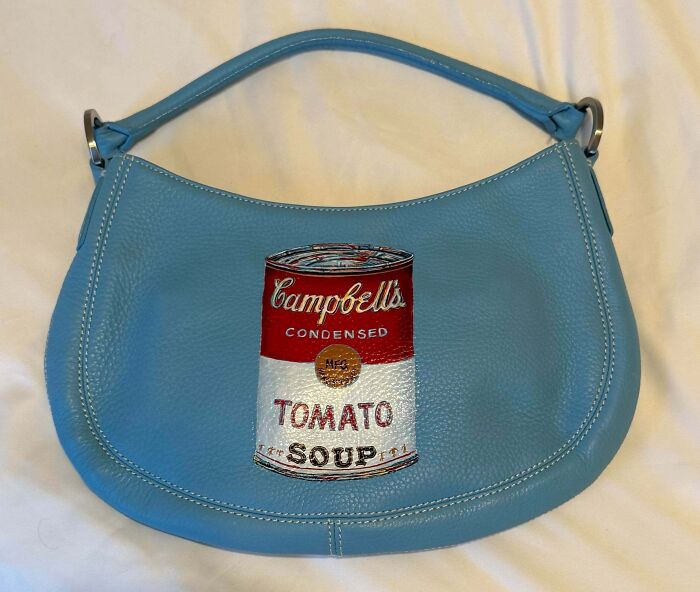 A light blue leather handbag with a Campbell's tomato soup can design, amazing thrift store finds.