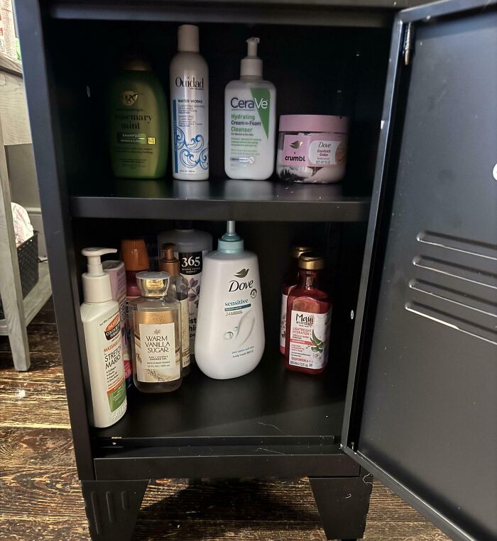A shared bathroom cabinet filled with various skincare products, illustrating daily roommate stories.