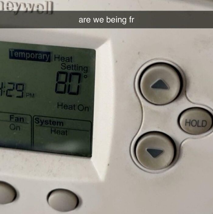 A household thermostat set to a high temperature of 80 degrees, highlighting roommate stories about energy bills.