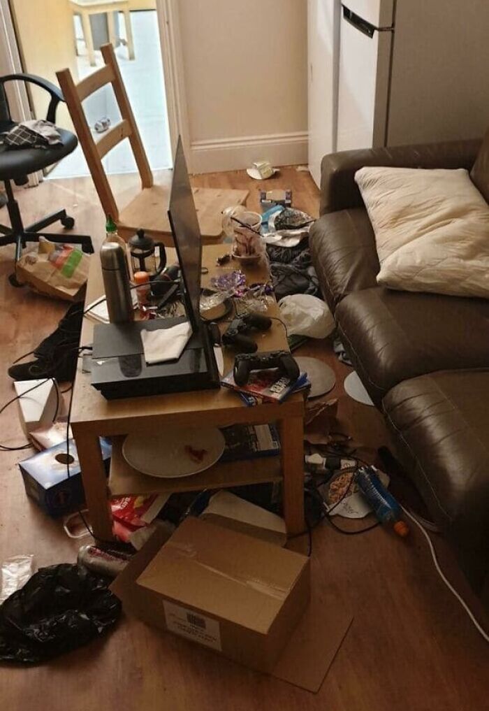 A messy living room with trash and clutter everywhere, representing bad roommate stories.