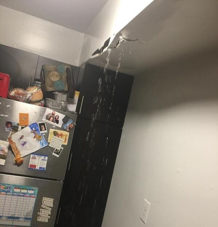 Water leaking from a cracked kitchen ceiling, illustrating terrible roommate stories.