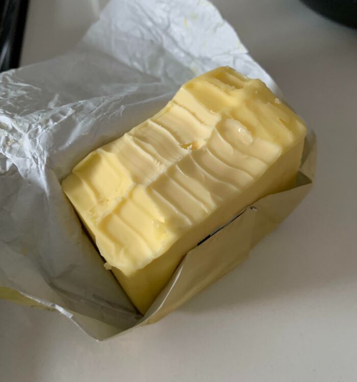 A block of butter with knife scrapes showcasing roommate stories about poor kitchen sharing