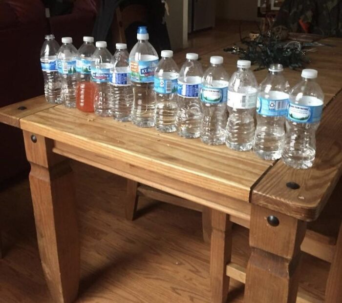 Roommate stories showing a wooden table crowded with half-empty plastic water bottles.