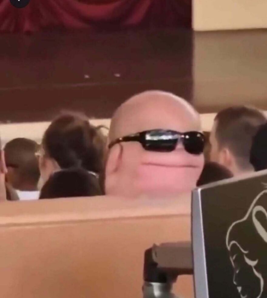 The back of a bald man head wearing sunglasses, creating a face-like illusion in out-of-context pics.