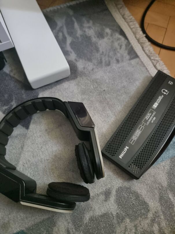 Black Philips vintage wireless headphones next to their transmitter unit, part of vintage tech finds