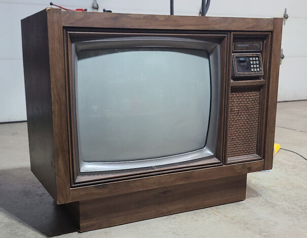 An old-school wooden console television set, a nostalgic item among vintage tech finds