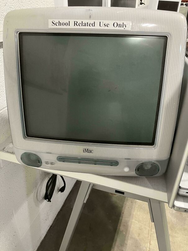 A vintage tech Apple iMac G3 computer with a CRT monitor