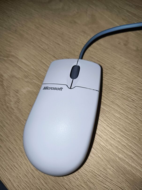 An old-school grey Microsoft computer mouse, highlighting vintage tech finds