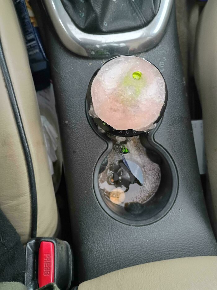 A frozen energy drink exploding in a car cup holder, illustrating questionable decisions