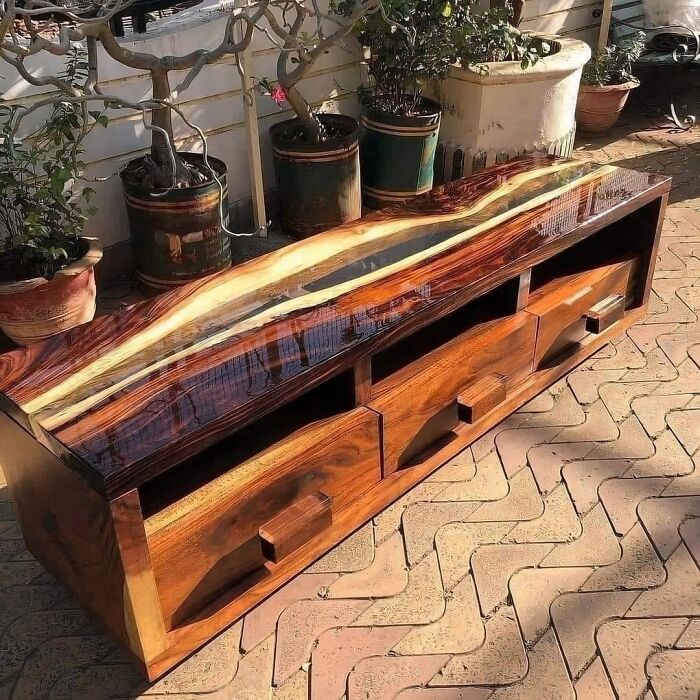 An elegant glossy wood and epoxy TV stand showcasing modern wooden creations for home decor