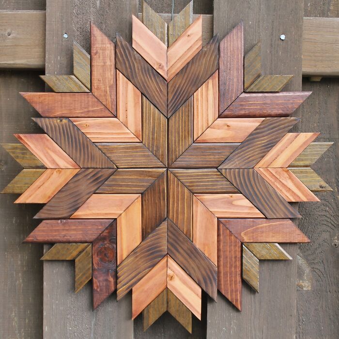 A geometric star pattern wall art piece made of clever wooden creations