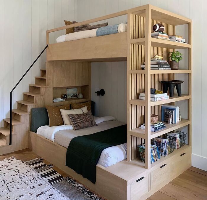 A custom wooden bunk bed structure with a built-in staircase and bookshelf, representing clever wooden creations