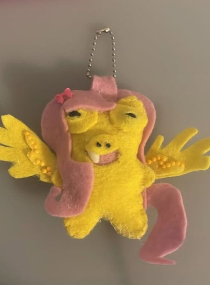 A poorly made yellow and pink felt pony keychain, an example of hilarious crafts that deserve to be shamed.