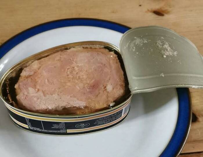 Opened tin of vintage canned meat typical of 1970s food packaging