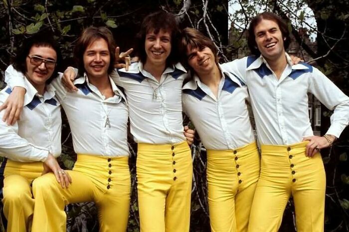 1970s group of men in matching yellow pants and white shirts