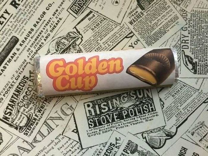 Golden Cup candy bar on retro newspaper background from the 70s