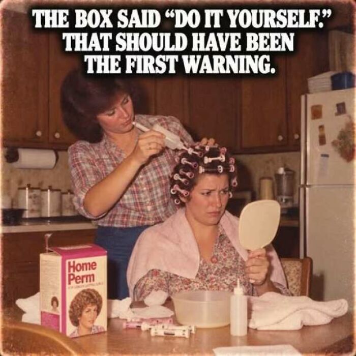 1970s woman helping another with home perm hair treatment at kitchen table
