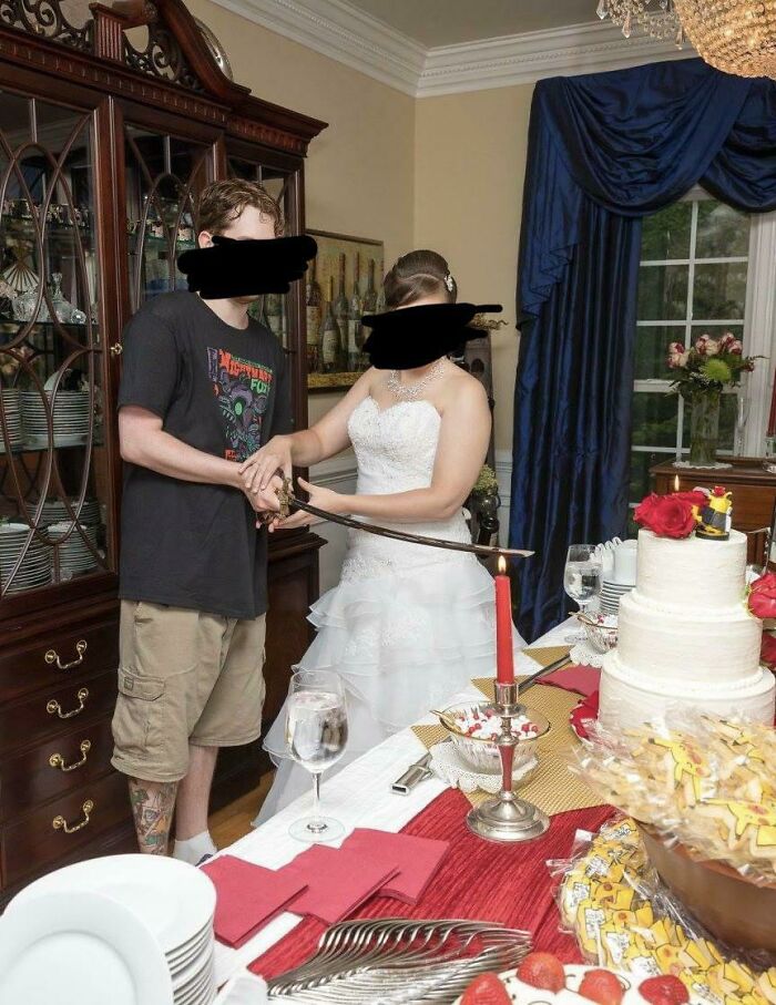 A groom in casual wear cutting a cake with a sword, among questionable wedding moments