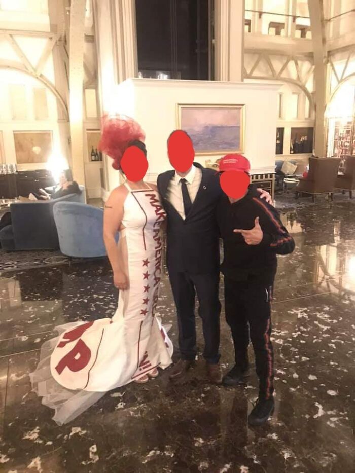 Bride in a MAGA themed dress posing at a reception, capturing questionable wedding moments.