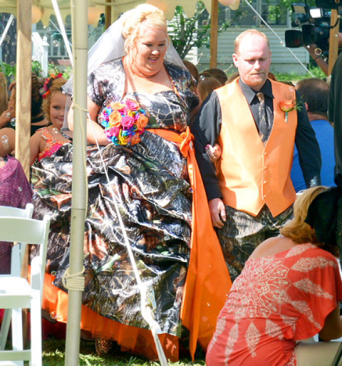Bride in a camouflage gown and orange sash at questionable wedding moments