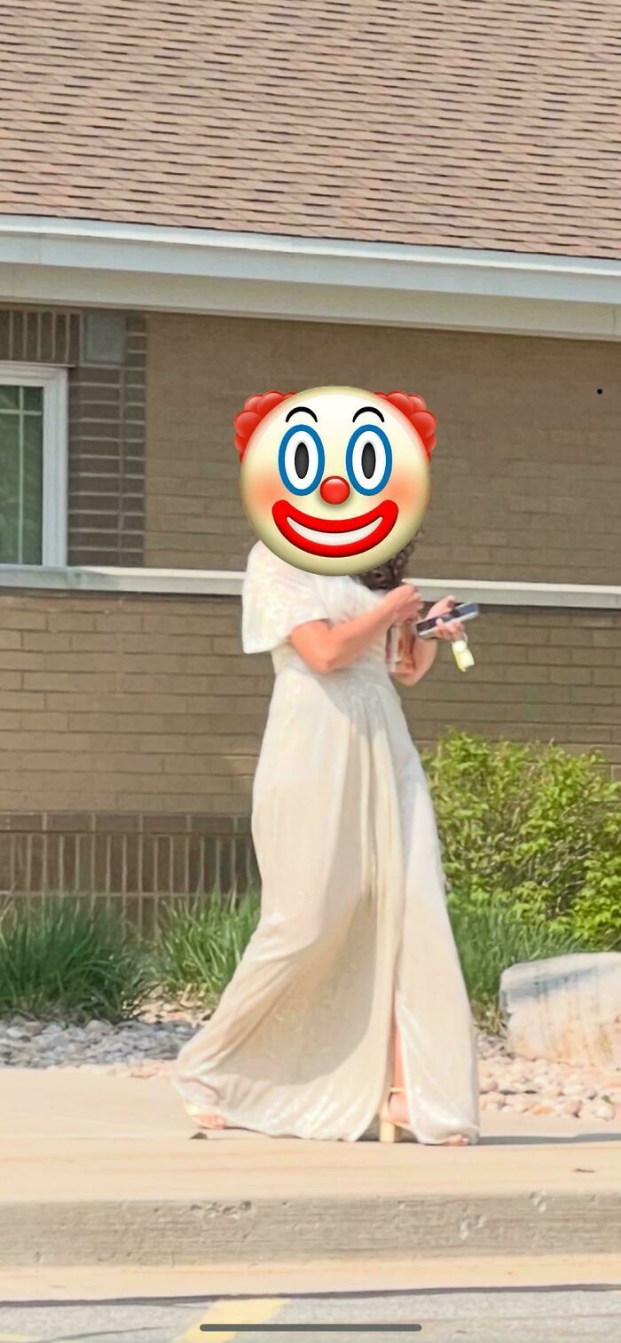 A woman wearing a white wedding gown with her face covered by a clown emoji, creating questionable wedding moments