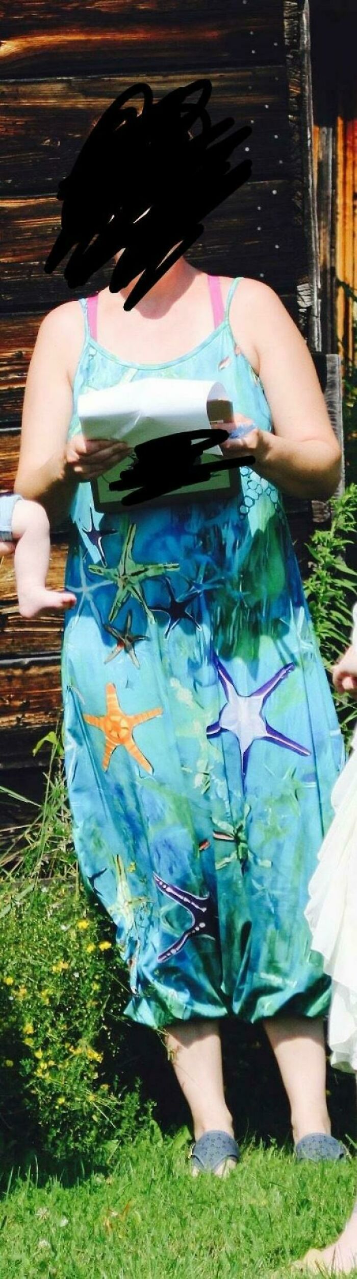 A woman wearing a bright blue starfish dress during questionable wedding moments