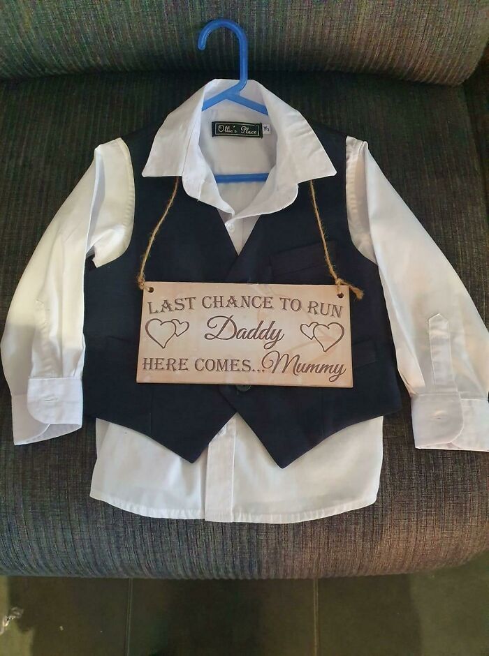 A questionable wedding moments sign for a page boy reading Last chance to run Daddy here comes Mummy