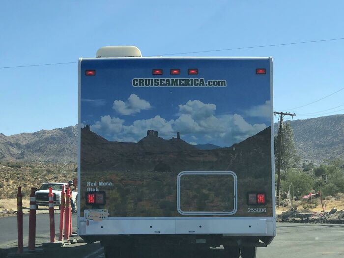 The back of an RV blends with the mountain background showing accidental camouflage