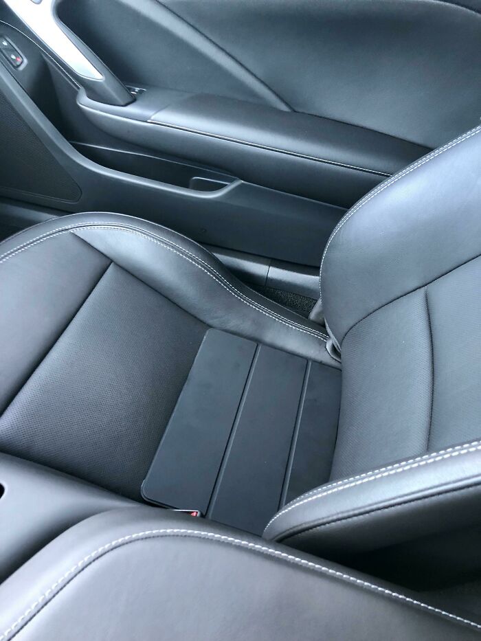 An iPad sitting on a black leather car seat showing accidental camouflage