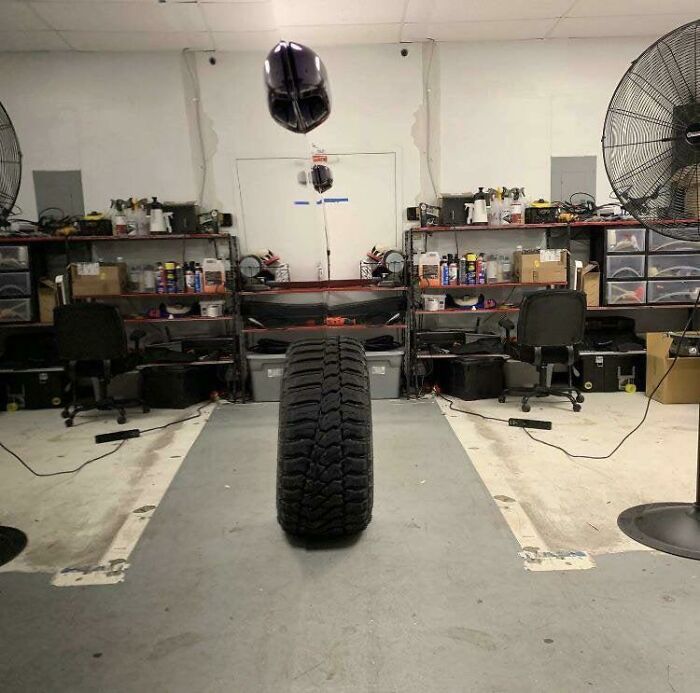 A tire standing on a grey floor creating a confusing example of accidental camouflage