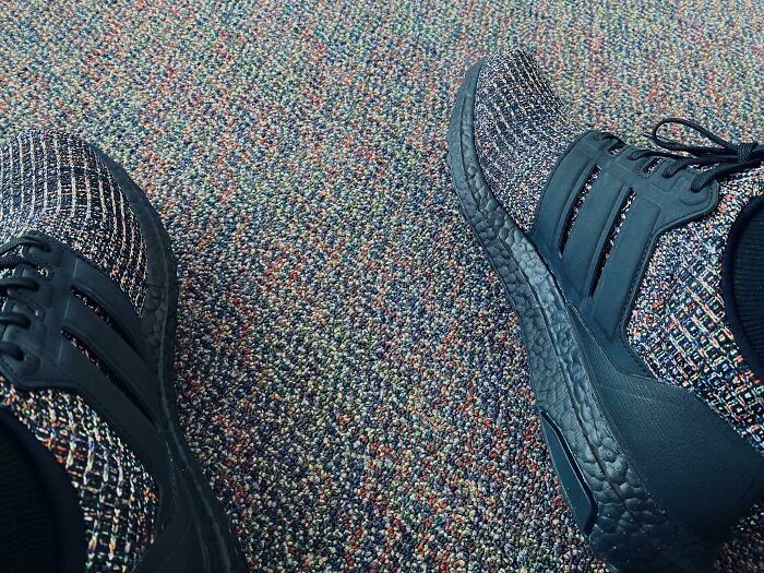Sneakers blending perfectly into speckled carpet for accidental camouflage