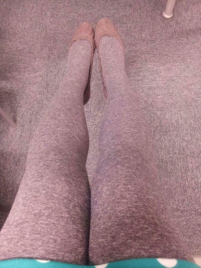 Accidental camouflage of legs in grey tights blending with grey carpet floor