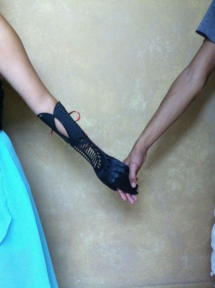 A black 3D printer prosthetic arm held by another person