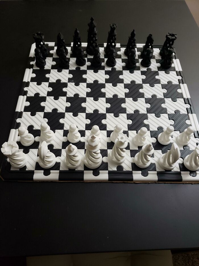 A custom chess set with spiraling pieces and a jigsaw board created by a 3D printer.