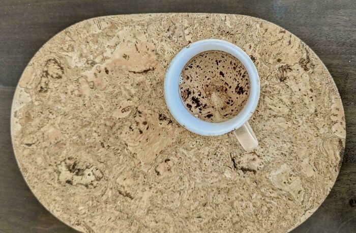 Coffee mug on cork placemat showing accidental camouflage with matching brown pattern
