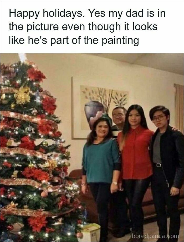 A funny example of accidental camouflage as a man blends perfectly into the background painting behind his family