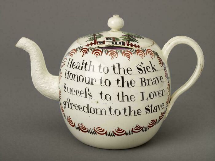 Antique teapot with painted inscription and decorative design artifact