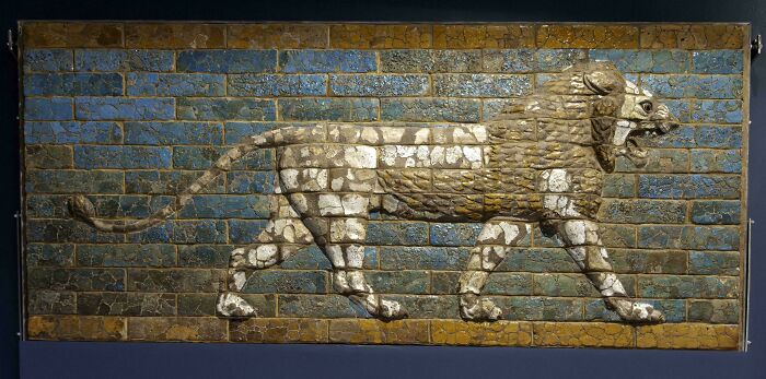 Strange ancient lion relief on glazed brick wall in archaeological artifact