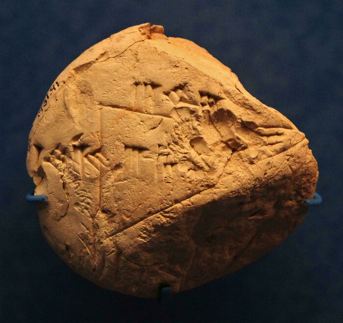 Ancient clay tablet with carved symbols and inscriptions discovery