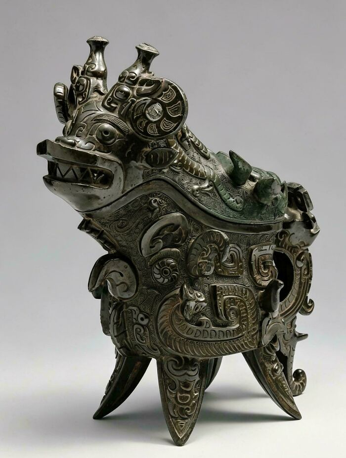 Ancient bronze artifact with intricate dragon design and patterns