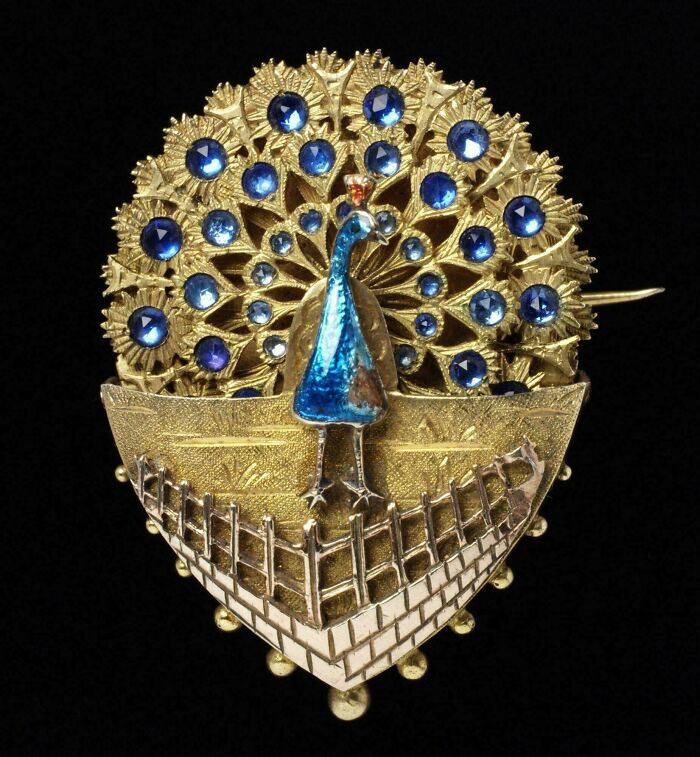 Vintage peacock brooch with blue gemstones and gold metalwork