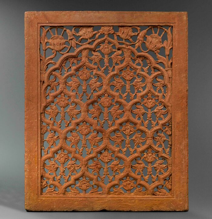 Intricately carved terracotta panel with floral design artifact